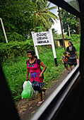 Women and girl in Hiriyala train station, view from train window, Sri Lanka