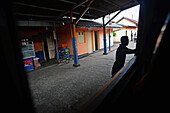 Silhouette of man in train station, view from window, Sri Lanka