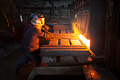 100mm square steel billet is removed from furnace as cold steel billet waits in foreground to be heated