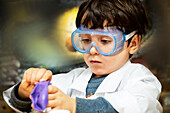 UK, Boy (4-5) making science experiments at home