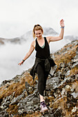 Canada, Yukon, Whitehorse, Woman walking on rocky hillside