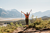 Canada, Whitehorse, Rear view of woman with hiking poles in landscape