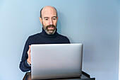 UK, Surrey, Man having virtual meeting via laptop