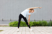 Young woman stretching outdoors