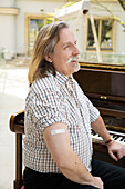 Austria, Portrait of pianist with adhesive bandage on arm