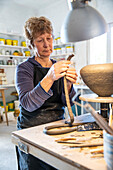 Spain, Baleares, Woman making ceramics in workshop