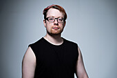 Studio portrait of man wearing eyeglasses and blank sleeveless top