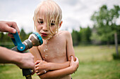 Canada, Ontario, Kingston, Boy (8-9) drinking from water hose