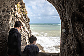 Jungen (6-7, 12-13) blicken aufs Meer, Sizilien, Italien