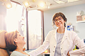 Smiling female doctor and patient in doctors office