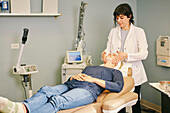 Beautician massaging patients face