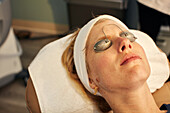 Close-up of woman with protective eyeglasses in beauty spa