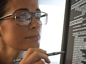 Close-up of computer programmer looking at computer screen