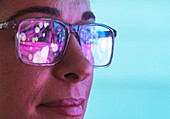 Futuristic reflections in scientists eyeglasses