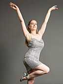 Young woman in sequin dress dancing