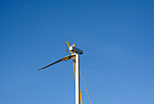 Wind turbine under construction against clear sky
