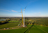 Aerial view of wind turbine under construction in field