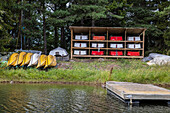 Rack of canoes on lakeshore