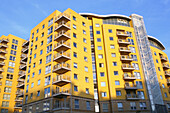 A Yellow Apartment Building With Windows To Reveal The Elevator, Near Basingstoke Train Station; Basingstoke, Hampshire, England