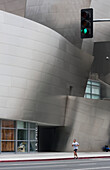 A Jogger Runs On A Road Beside A Modern Building; California, United States Of America