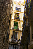 Ein gelbes Wohnhaus mit kleinen Balkonen; Barcelona, Spanien