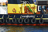 A Boat Lined With Rubber Tires On The Side; Hamburg, Germany
