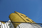 Low Angle View Of A Rounded Brick Wall And Black Railing, Camden; London, England