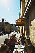 Eating On Outdoor Seating At A Restaurant In Marais District; Paris, France