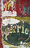 Worn And Peeling Signs Painted On A Wall; Paris, France