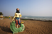 Buddhist Statues On The Beach At The Water's Edge; Visakhapatnam, Andhra Pradesh, India