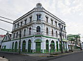 A Green And White Building On A Street Corner; Punta Arenas, Chile