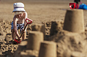 Boy Making Sandcastle On Treyarnon Bay Beach; Cornwall, England