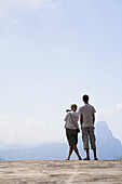 A Couple Stands At A Lookout With A View Over The Valley Between Luang Prabang And Vang Vieng; Laos