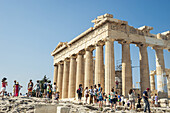 Touristen zwischen den Säulen der Akropolis; Athen, Griechenland