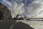 Large Waves Crash Against The Shoreline And Sea Stacks On The Southern Shore Of Iceland, Near Vik; Iceland