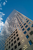 Wolkenkratzer, in dessen Fenstern sich ein anderes Gebäude spiegelt, mit blauem Himmel und Wolken; Denver, Colorado, Vereinigte Staaten von Amerika