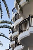 Rounded Balconies On A Residential Building With Palm Fronds And Blue Sky; Paphos, Cyprus