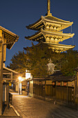 Japanese Pagoda And Small Traditional Street At Night; Kyoto, Japan