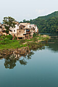 Tranquil River With Houses Along The Water's Edge In A Small Village Near Wuyuan; Jiangxi Province, China