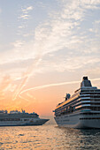 Cruise Ships In The Harbour At Sunset, Kowloon; Hong Kong, China