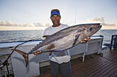A Fisherman Poses With A Dogtooth Tuna (Gymnosarda Unicolor); Tahiti