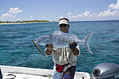 Fisherman Holding Green Jobfish (Aprion Virescens); Tahiti