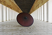 Red Umbrella In A Temple Corridor; Bagan, Myanmar