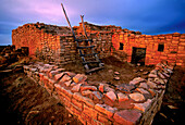 Sunset and shadows fall across a building in Lowry Pueblo, an archeological site located in Canyon of the Ancients National Monument. A treasure of Ansazi Indian ruins in Colorado, the pueblo was constructed around 1060 AD atop abandoned pit houses from an earlier period of occupation. A total of 40 rooms and 8 kivas at its peak in the early 11th century, it was home to approximately 100 people. The 176,000 acre monument of federal land administered by the Bureau of Land Management includes 20,000 archeological sites; Colorado, United States of America