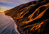 Aerial view illuminates eroded slopes above the waves on the coast of California's King Range National Conservation Area (NCA). The area encompasses 68,000 acres along 35 miles of landscape too rugged for highway building, giving the remote region the title of California’s Lost Coast. It is the Nation's first NCA, designated in 1970; California, United States of America