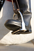 Close up of a riding boot on a stirrup