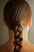 Back view of young woman head with one braid