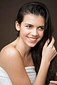 Woman touching her long wet hair