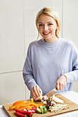 Smiling Woman Chopping Vegetables