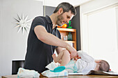 Father Changing Baby Girl Diaper